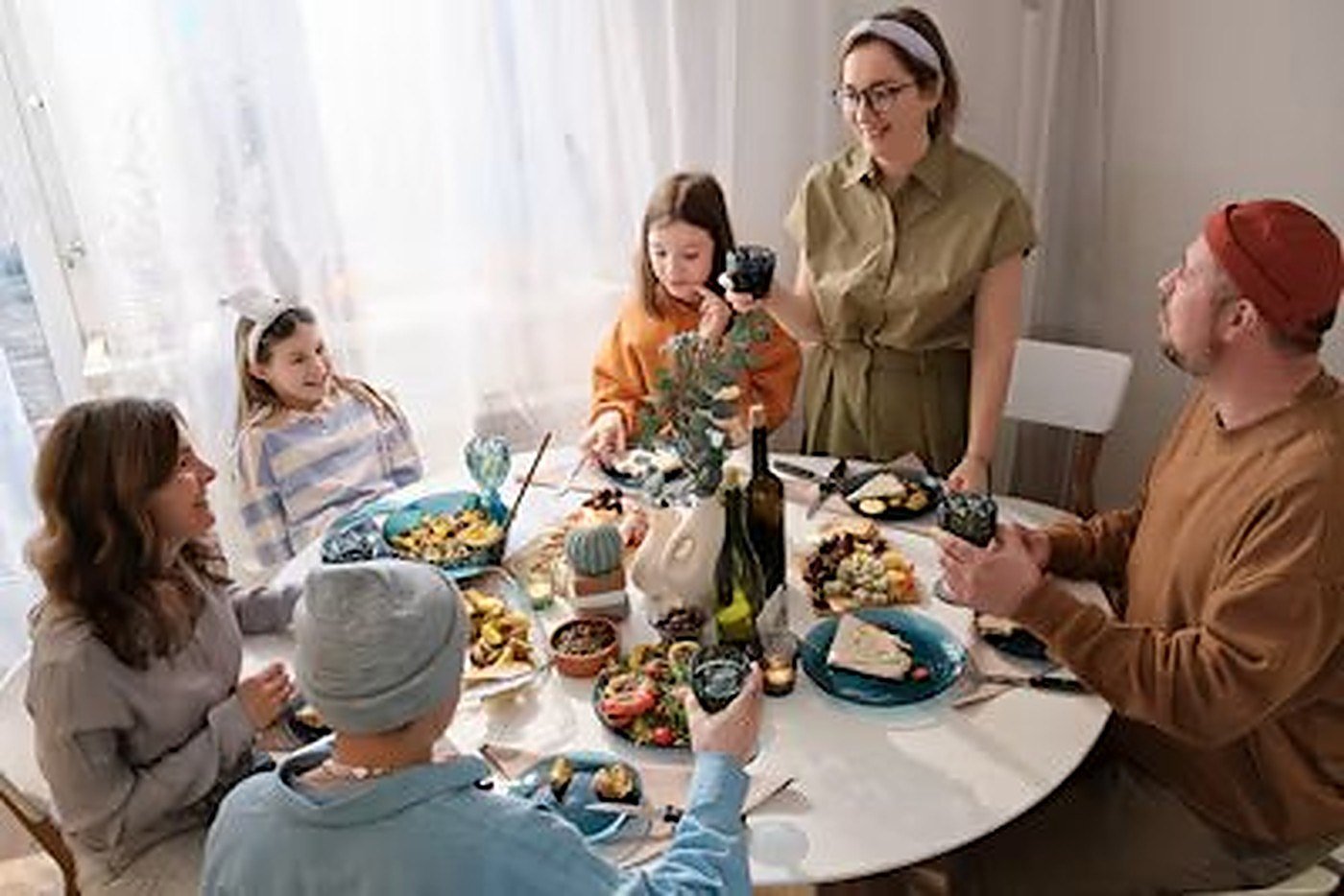 A family sharing a meal together around the table