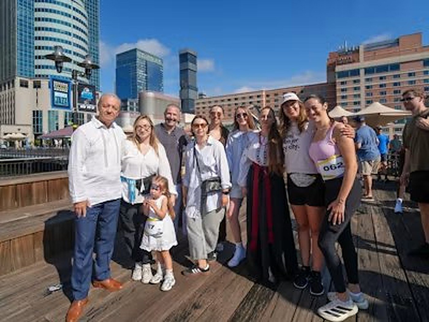 A mixed group of all ages posing together at a waterside outing