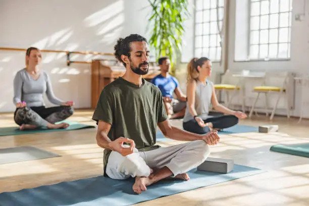 A small group meditating together in a calm studio